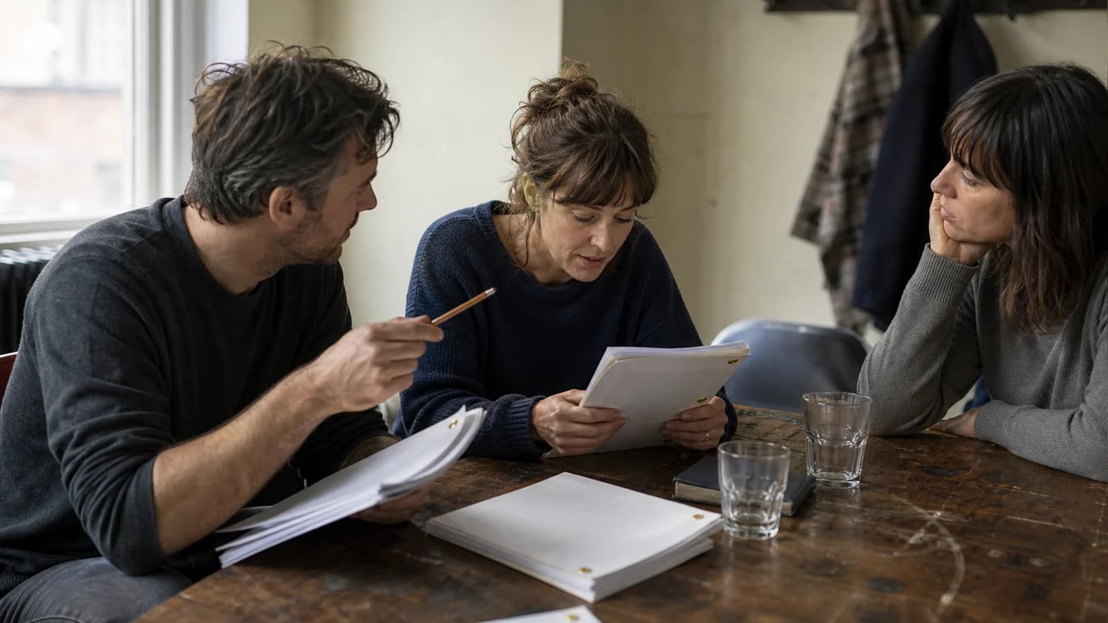 A writer and two actors pause a table read to identify the choice missing from a crucial scene